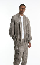 Man wearing a gray textured jacket and pants with 'La Haine Inside Us' text on a white background