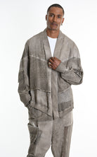 Man wearing a textured gray jacket and pants on a white background