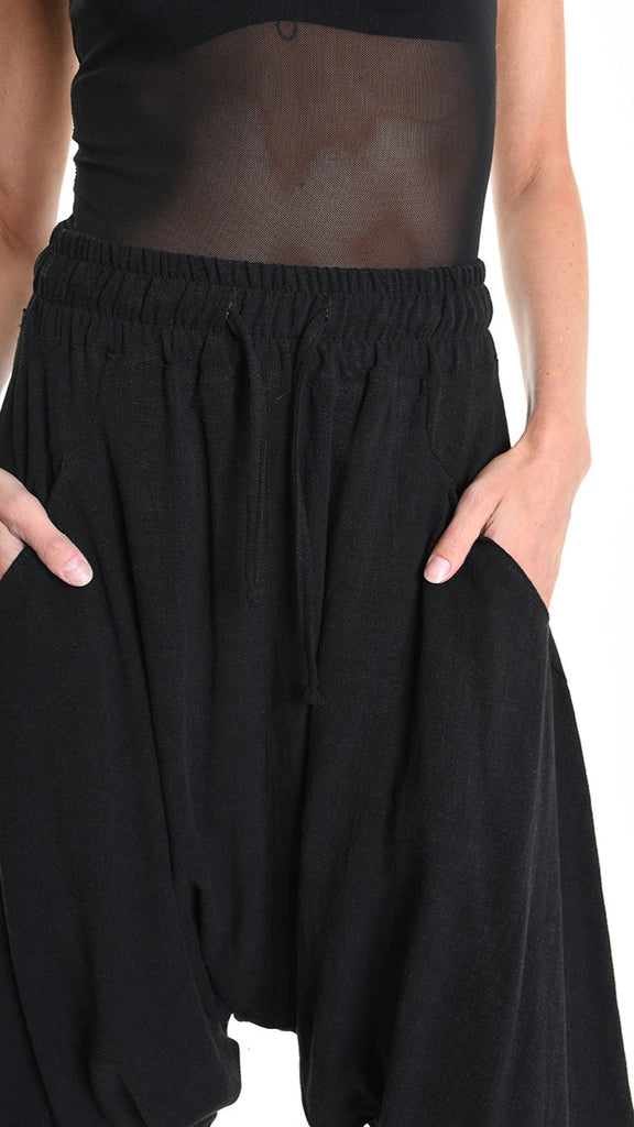 Unisex black viscose linen pants with elastic waist and low crotch fit.