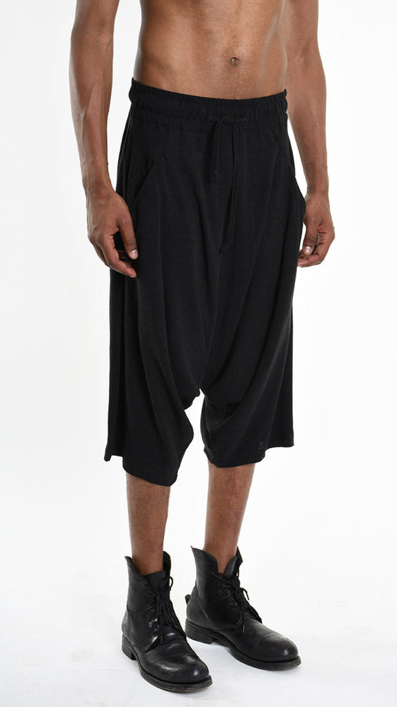 Unisex black pants/shorts with low crotch and elastic waist, made from viscose linen blend.