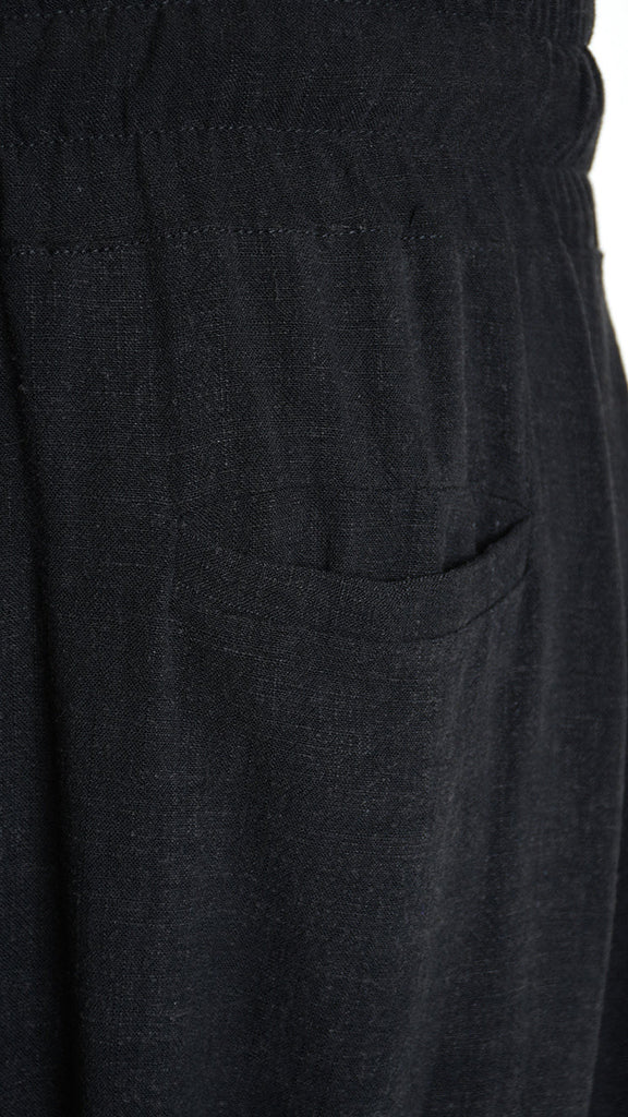 Unisex black pant with low crotch and elastic waist, made from viscose linen blend.