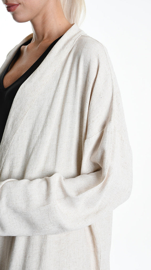 Unisex ecru cardigan with asymmetrical design and button closure, crafted from viscose and linen.