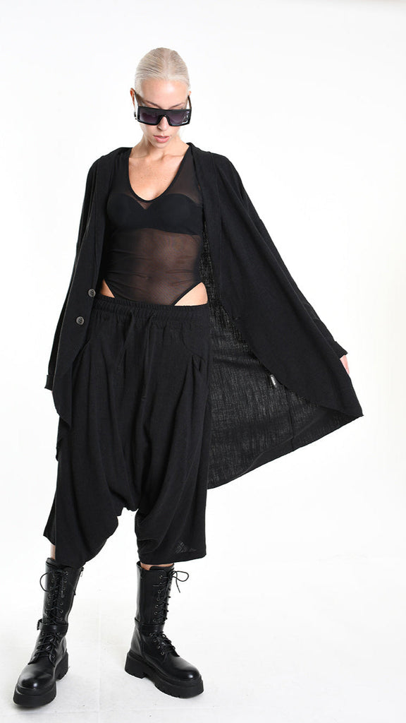 A33M M101325 CARDIGAN in black, unisex asymmetric design, worn by model.