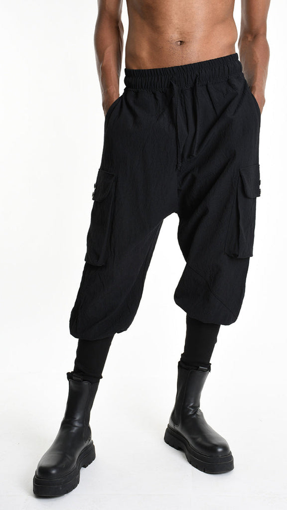 Baggy cotton jacquard unisex trousers in black with elastic waist and ribbed bottom.