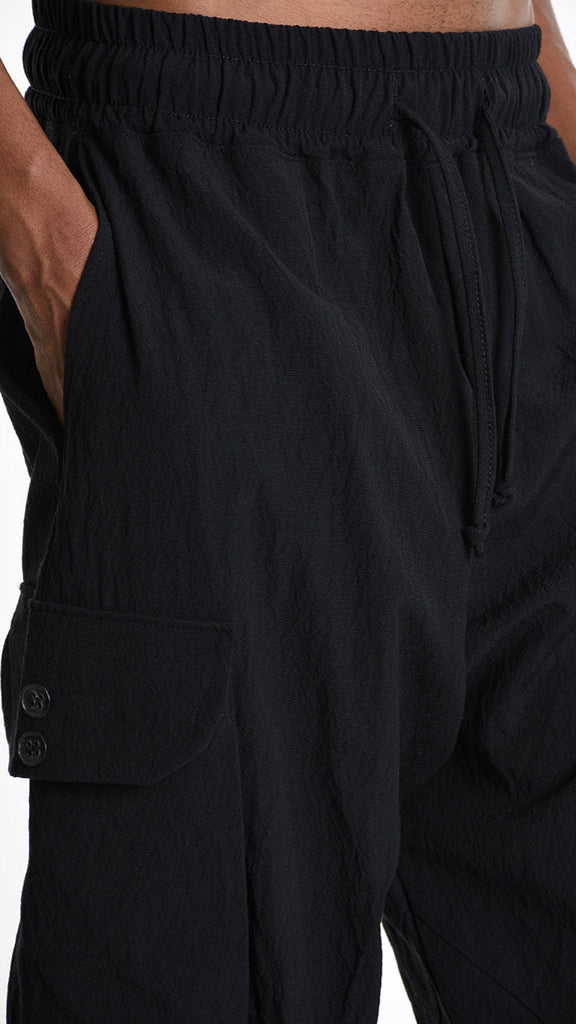 Baggy black cotton jacquard trouser with elastic waist and drawstring.