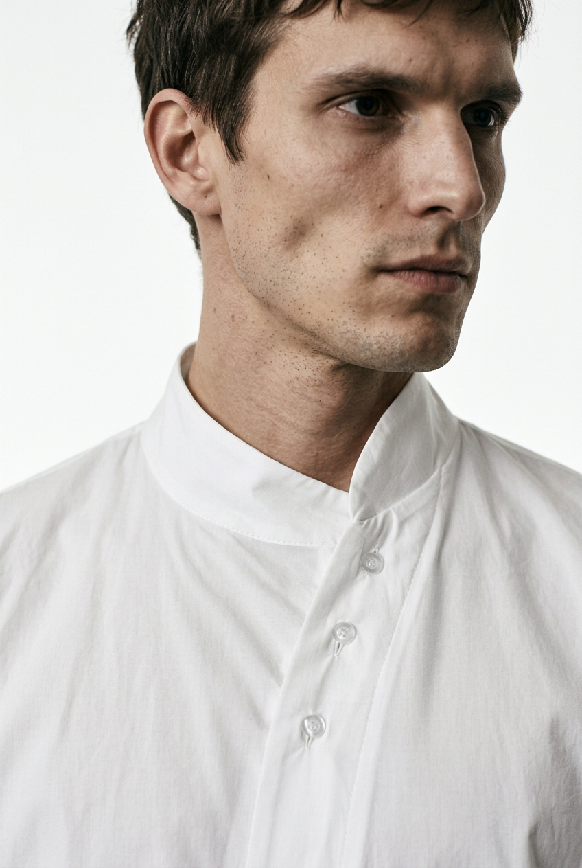 LA HAINE INSIDE US LM226 white long cotton stretch shirt — close-up of the asymmetric collar and button placket