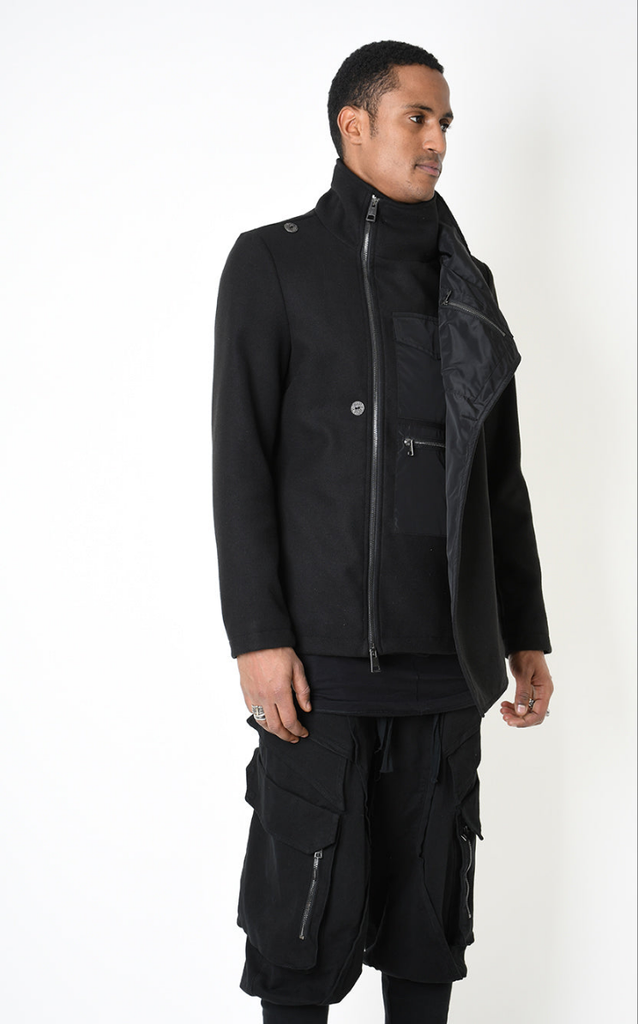 A33B LM18525 COAT with asymmetrical nylon panel and dual closure in black.