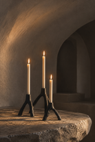 Candles lit in a vaulted interior