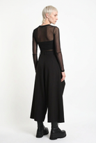 LA HAINE INSIDE US W5517 oversized techno stretch trousers in black — rear three-quarter editorial view