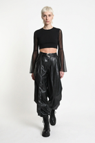 LA HAINE INSIDE US W5468 faux leather trousers in black — walking editorial view