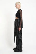 LA HAINE INSIDE US W5468 faux leather trousers in black — side editorial view with hanging sash