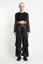 LA HAINE INSIDE US W5468 faux leather trousers in black — front editorial view
