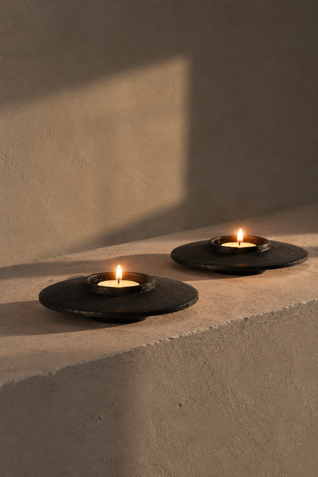 Lit on a plaster ledge at dusk