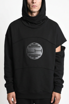 LA HAINE INSIDE US M1334 hoodie in black — circular chest print and sleeve attachment detail on male model