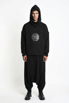 LA HAINE INSIDE US M1334 hoodie in black — front view on male model with long sleeves attached