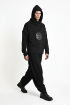 LA HAINE INSIDE US M1334 hoodie in black — walking view on male model with hood up