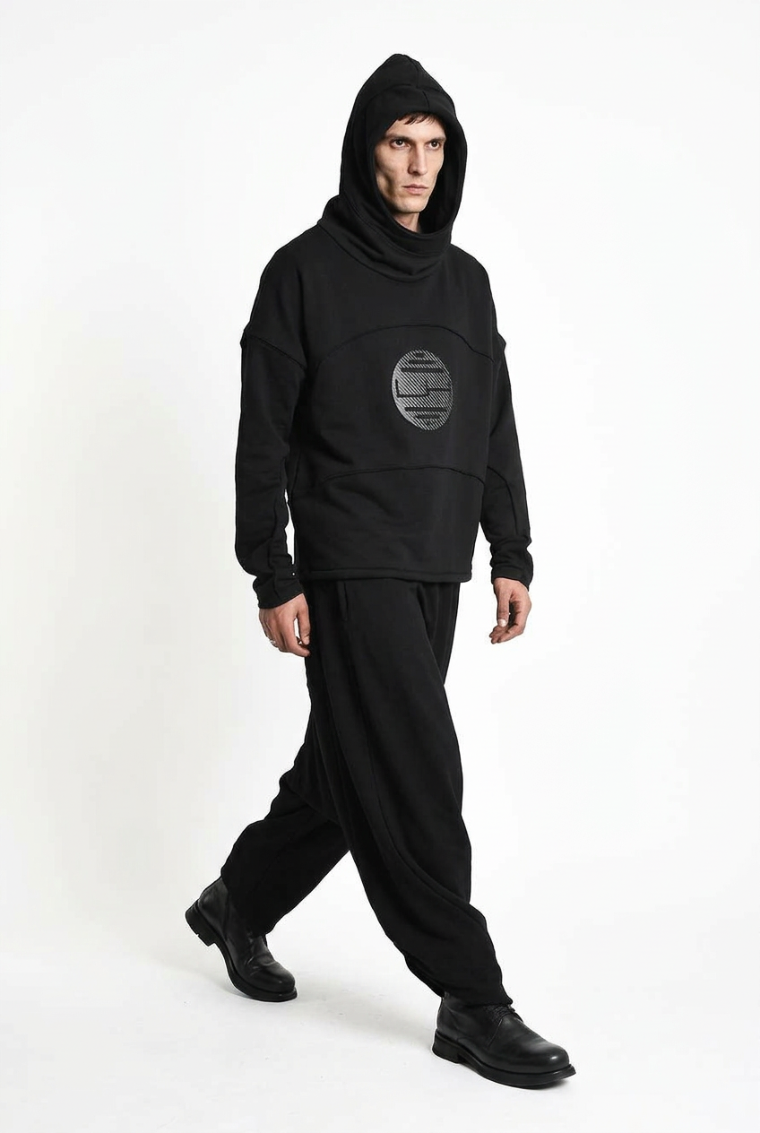 LA HAINE INSIDE US M1334 hoodie in black — walking view on male model with hood up