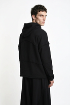 LA HAINE INSIDE US M1334 hoodie in black — over-the-shoulder back view on male model