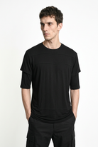 LA HAINE INSIDE US M1358 T-shirt in black — front view with hands in trouser pockets