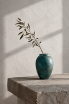Stone table with an olive branch