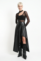 LA HAINE INSIDE US W5418 asymmetric faux leather skirt in black — three-quarter front editorial view
