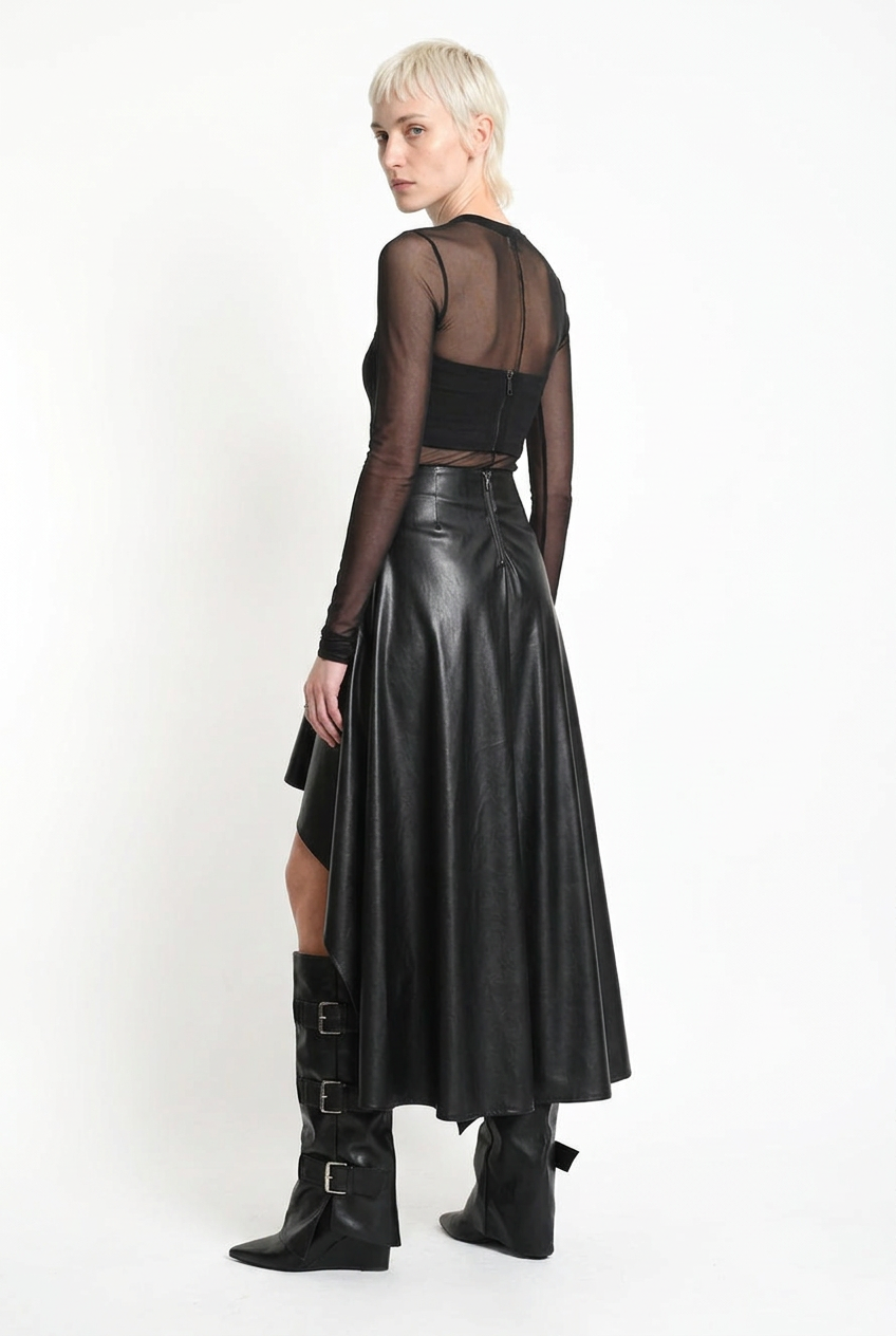 LA HAINE INSIDE US W5418 asymmetric faux leather skirt in black — rear three-quarter editorial view showing back zip