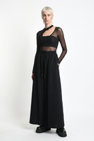 LA HAINE INSIDE US W5451 black embossed fleece palazzo trousers, three-quarter front view with hand in pocket