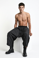 LA HAINE INSIDE US W5488 black baggy drop-crotch trousers, male model, seated view